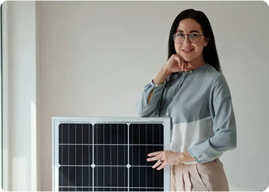 Satisfied customer standing next to a solar panel